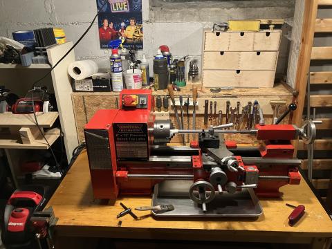 the lathe after cleaning, with organized tools behind and around it