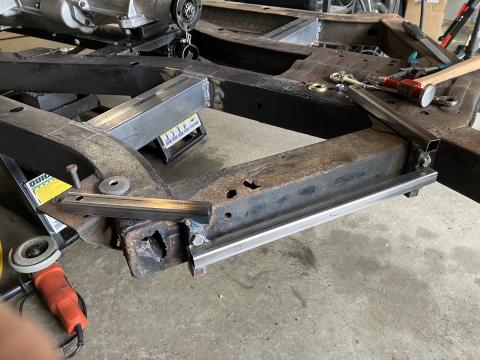 TR6 frame repair jig, welded square bar bolted into the trailing arm mounts