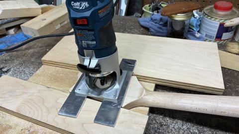 router on two aluminum skis over the back of the guitar neck headstock