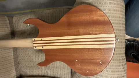 rear of the bass body, with the light showing shimmering grain lines