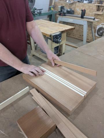 wood pieces aligned into a panel on a workbench 